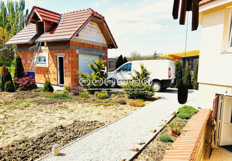 Family house in Ratkovce with an unfinished construction, delivery, and landscaped garden.