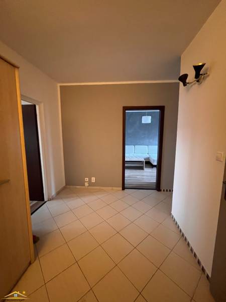 Hallway in a 2-room apartment with a view of the floor with a wooden decor.