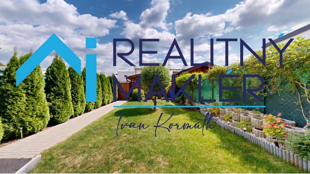 The garden of a family house in Stupava with a well-maintained lawn and planting.