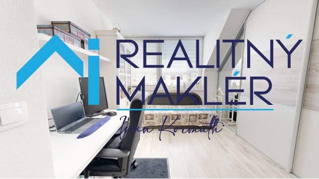 Home office in a family house with a desk and a bed, floor with wooden decor.