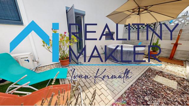 In the exterior of a family house in Stupava, there are sun loungers, a hot tub, and a sunshade.