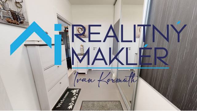 Interior of a family house with white furniture and a mirrored wardrobe. Stamp and logo on the image.