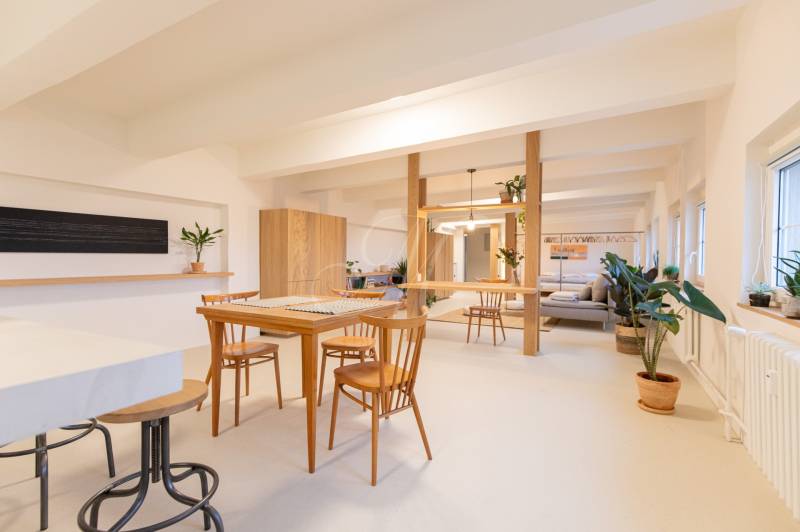 Interior of a 3-room apartment with a dining table, wooden decor, and plants.