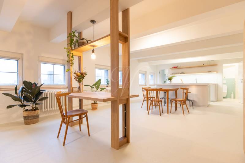 A bright interior of a 3-room apartment with wooden decor and houseplants.