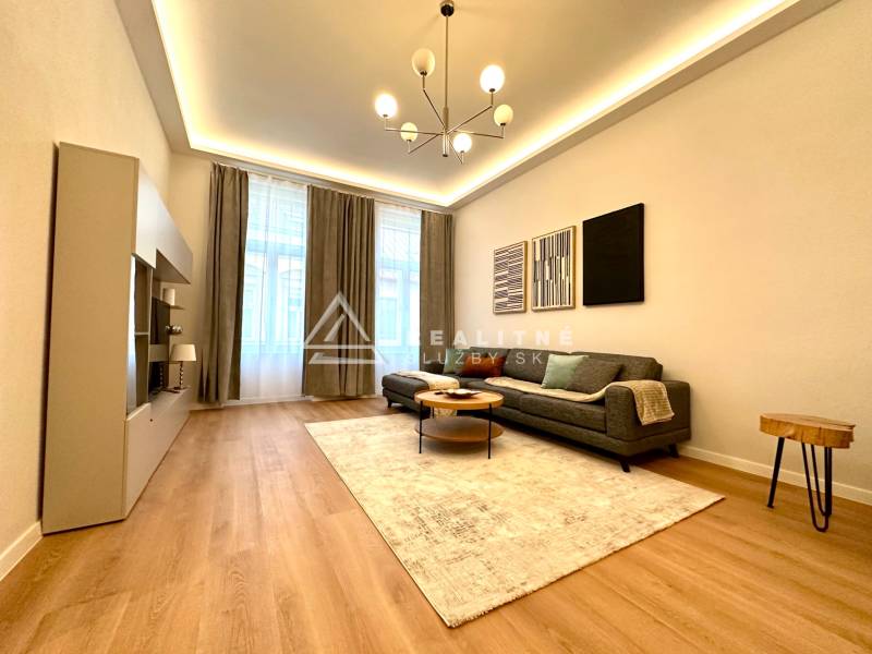 Living room of a two-room apartment with a wooden decor floor and stylish lighting.
