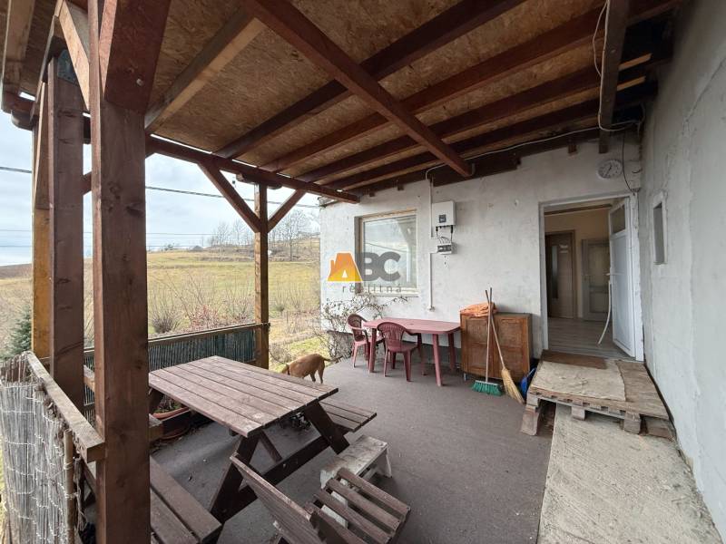 Terrace of the cottage on Zánemecká Street in Hriňová with a wooden shelter and outdoor furniture.