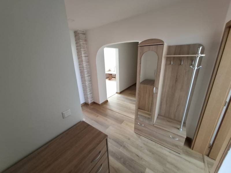 Interior with wood-decor flooring and wooden furniture in a 5 or more room apartment.