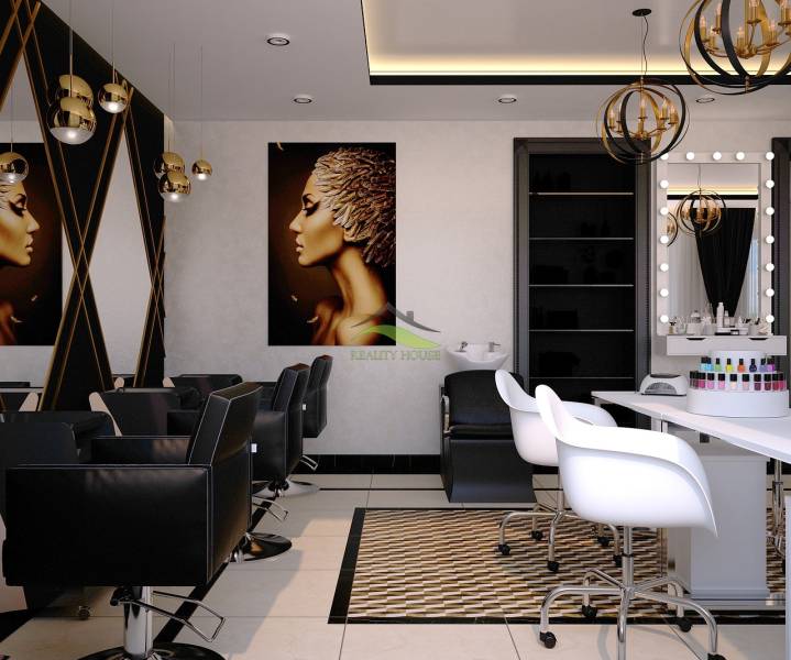 Interior of commercial spaces with hairdressing chairs, mirrors, and decorative lighting.