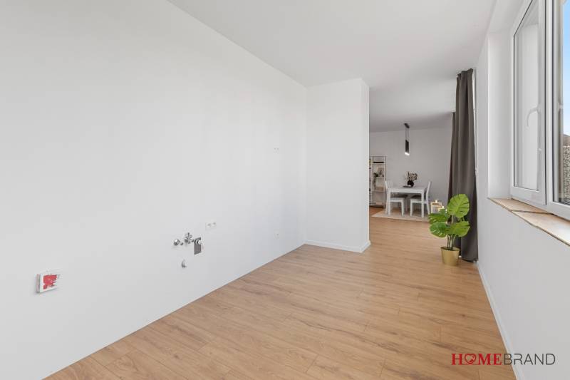 Interior of a 3-room apartment with a wooden decor floor and a dining area.