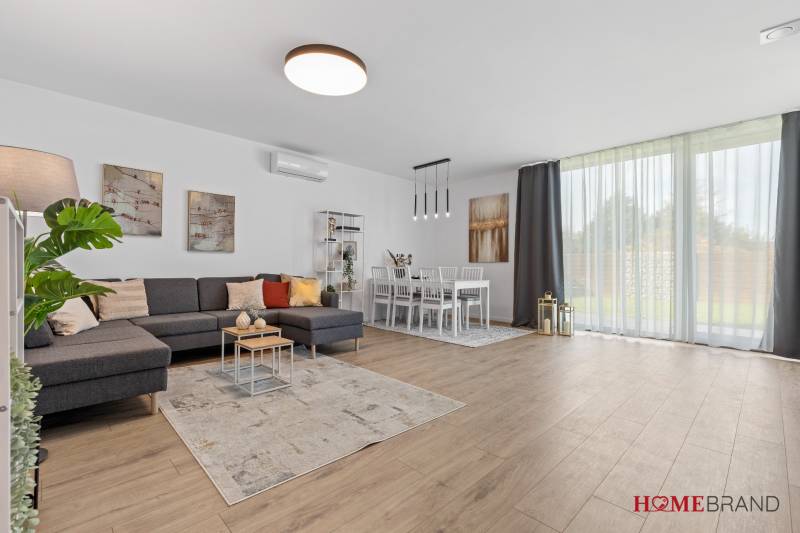 Living room in a 3-room apartment with a comfortable sofa and a wooden decor floor.