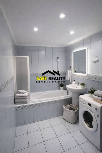 Bathroom in a 2-room apartment with a bathtub, sink, and washing machine, light tiles and decorations.