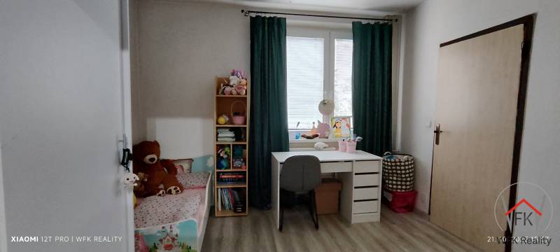 Children's room with a bed, desk, and shelf, 3-room apartment, floor with wooden decor.