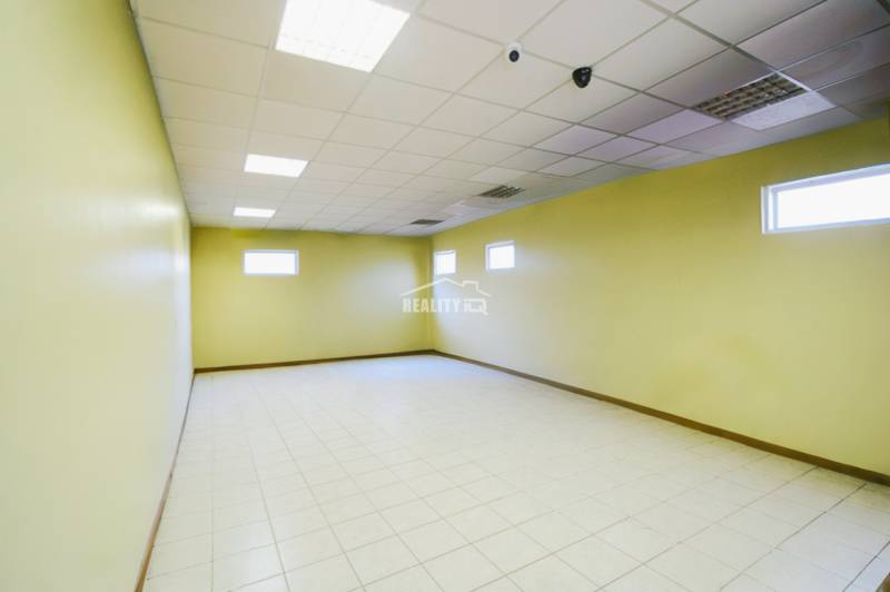 A bright room with pale walls and tiles in the production area.