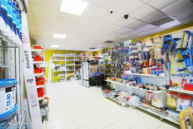 Interior of a workshop with shelves full of building materials and tools.