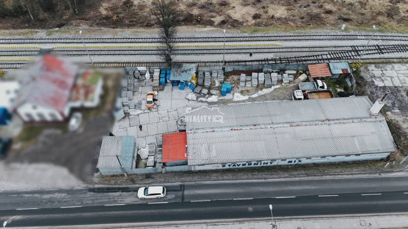 The production premises in Konská, next to the railway track, contain materials and vehicles.