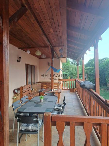 The terrace of a family house on Hodská Street in Galanta with seating and wooden elements.