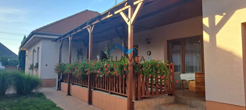 A family house on Hodská Street in Galanta with a wooden terrace and floral decorations.