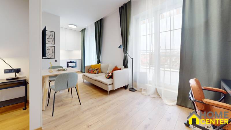 Bright 1-room apartment with wood-patterned flooring, comfortable seating, and a large window.