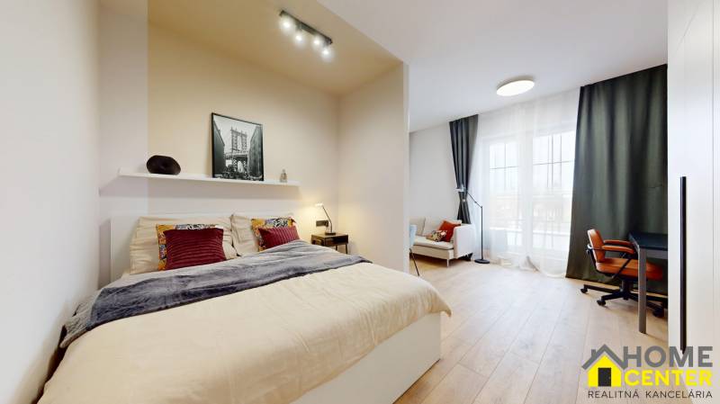 1-bedroom apartment with a bed, sofa, desk, and wood-patterned flooring.