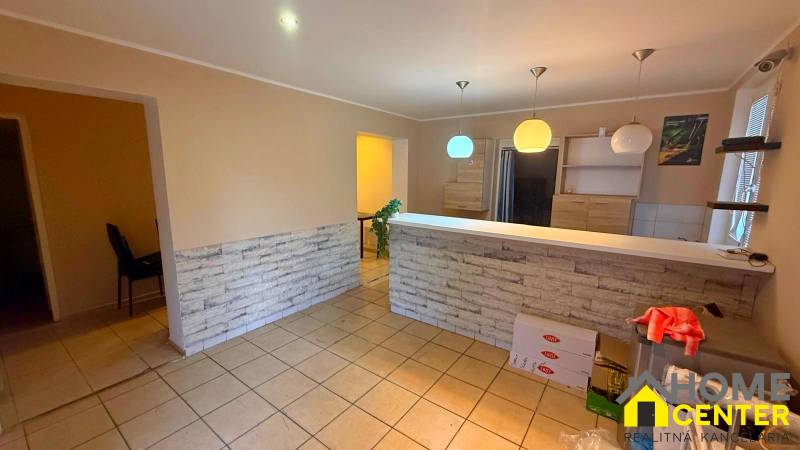 A kitchen counter in a gastro space with lights and brick cladding.
