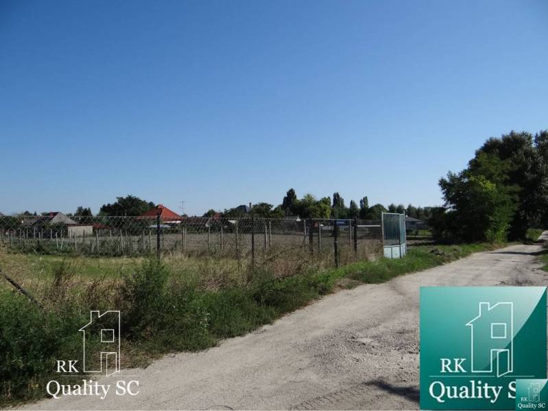 Plots - housing on Vrbová Street in Jelka, enclosed by a wire mesh fence.