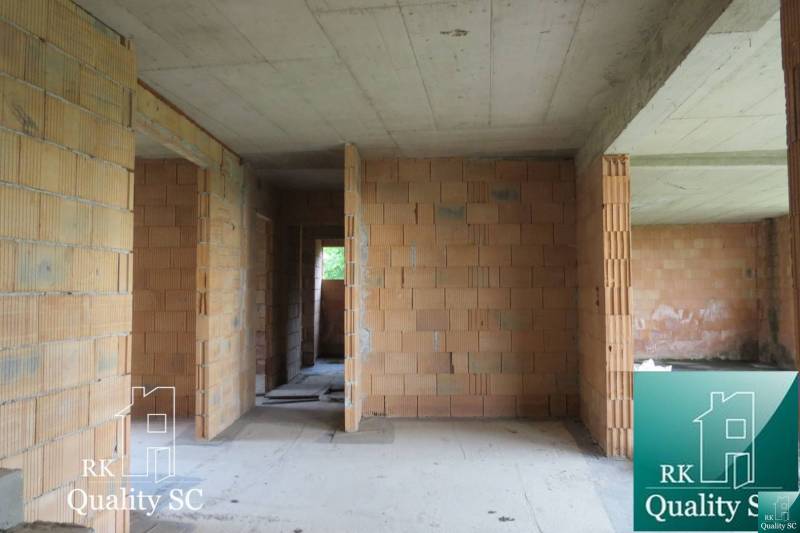 A family house with brick walls and a concrete ceiling, without floor finishing.