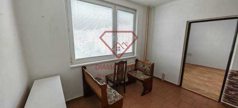 Interior of a 3-room apartment with furniture, wood-patterned flooring, and a large window.