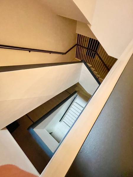 A view of the staircase leading down in a residential building of a 2-room apartment.