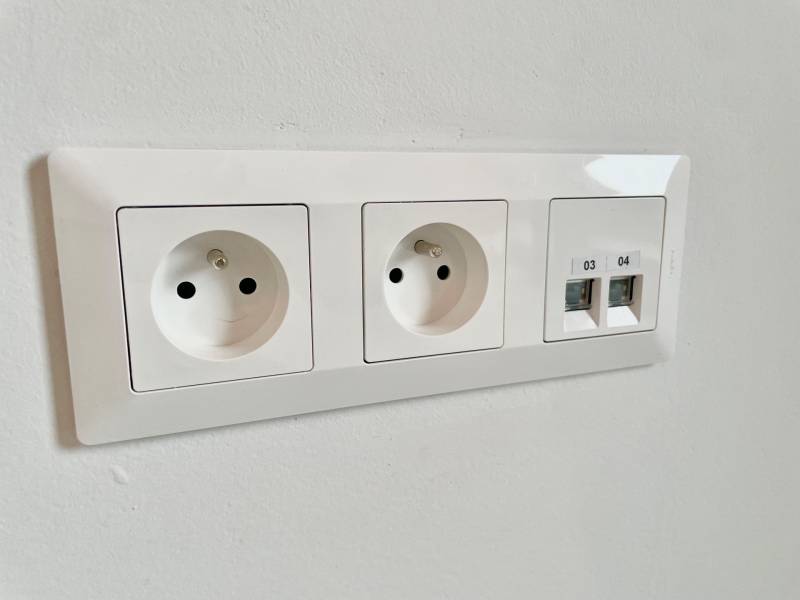 Double electrical outlet and two ethernet ports on the wall.