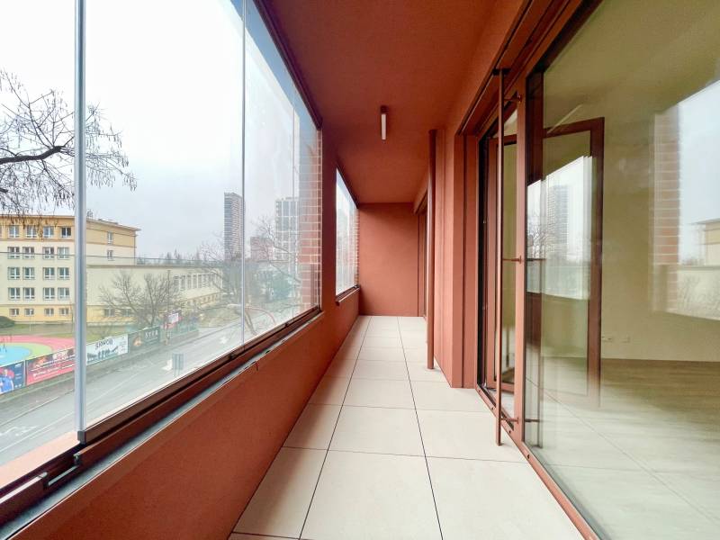 A glazed balcony with a view of the school and the city street in Bratislava on Košická.