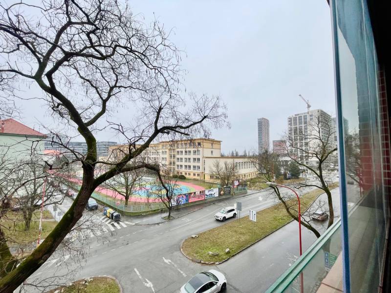 View of Košická Street in Bratislava with trees and urban architecture.