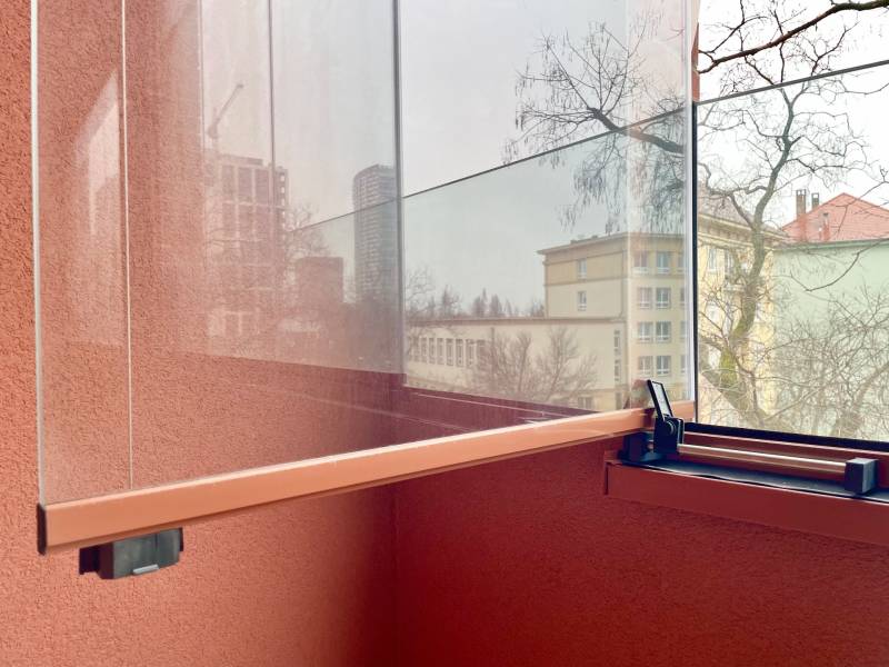 A glazed loggia of a 2-room apartment with a view of the district in Bratislava.