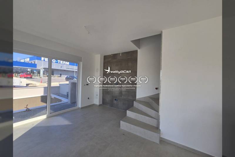 Interior of a family house with tiles and a staircase, view of the street.