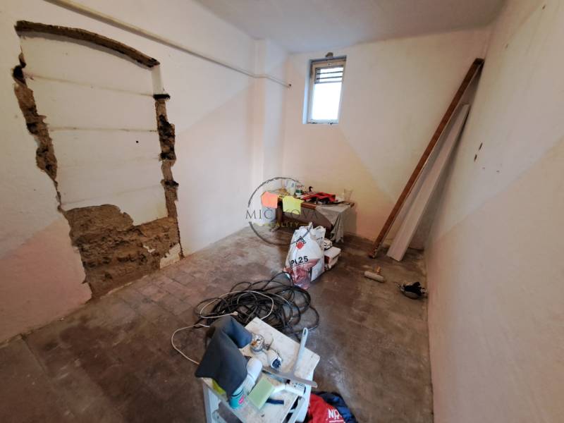 A room in a family house with tools and building materials on the floor.
