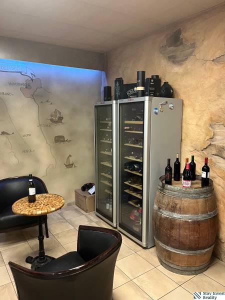 Interior commercial spaces with wine refrigerators, a barrel, and a map wall.