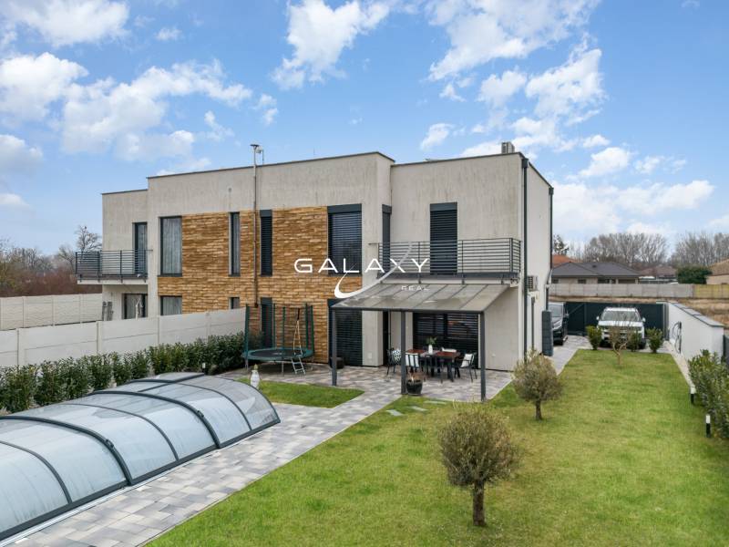 A family house in Dunajský Klátov with a terrace, swimming pool, and well-maintained garden.