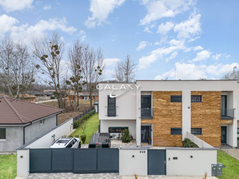 A family house in Dunajský Klátov with a modern facade and a landscaped garden.