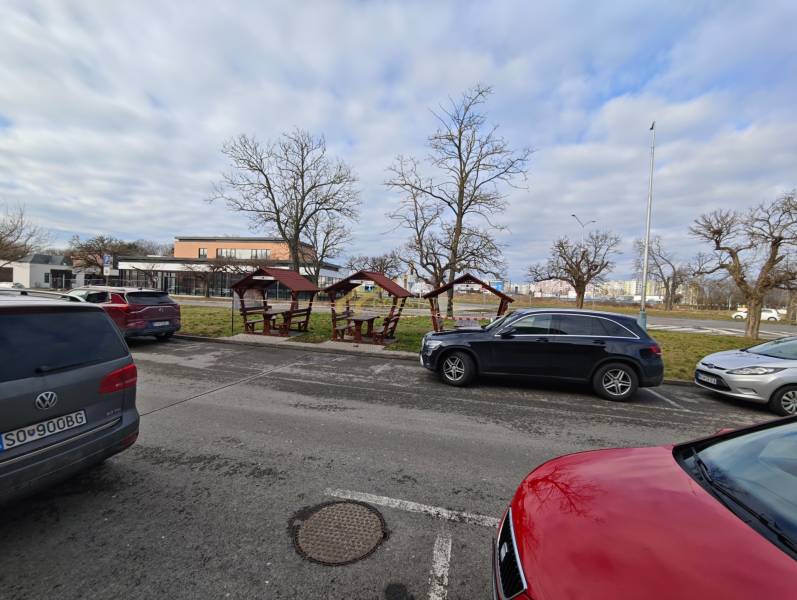 Parking on Obchodná Street in Michalovce near the dining areas with gazebos.