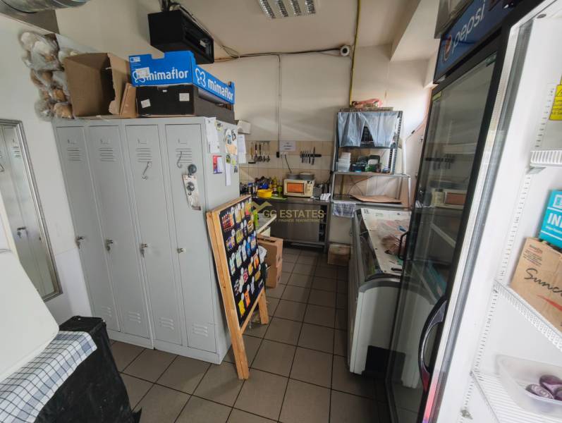Space of a gastro establishment with storage cabinets and cooling showcases.