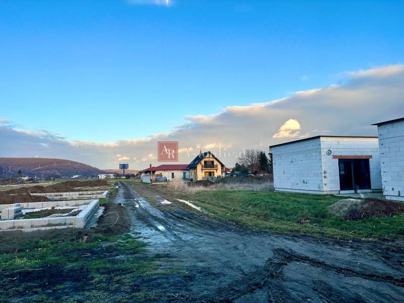Residential building plots on Poľnohospodárska Street in Trenčín with unfinished houses.