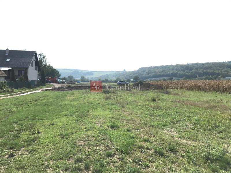 Countryside near Trenčín on Poľnohospodárska Street, surrounded by fields suitable for residential plots.