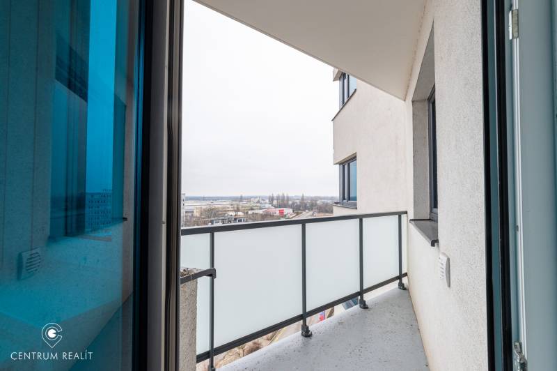 The balcony of a 2-room apartment on Rybničná Street in Bratislava, overlooking the cityscape.