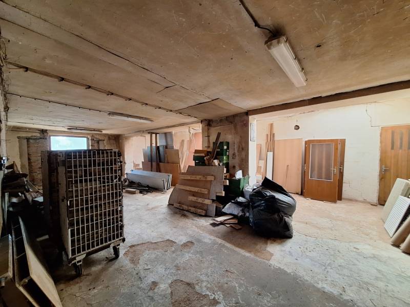 Warehouses and halls with various construction waste and equipment, including old doors.