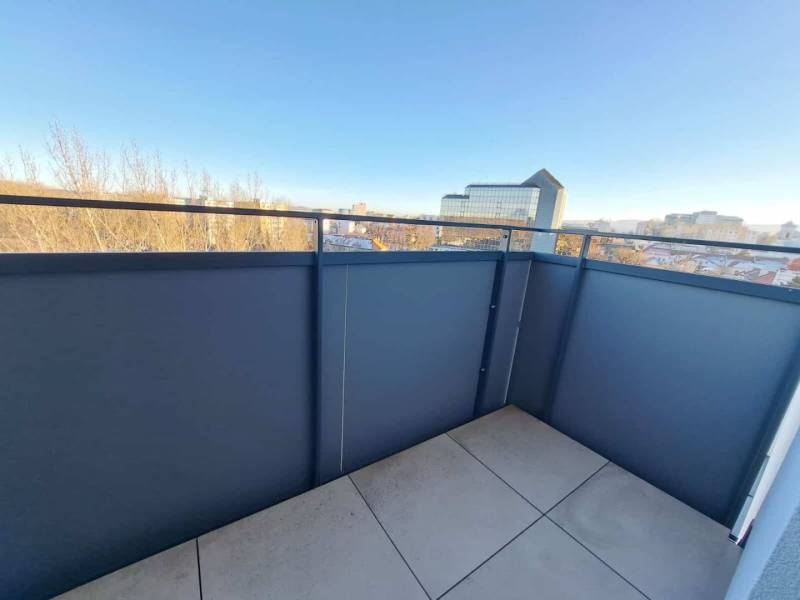 A balcony in a 2-room apartment with a view of the Poprad panorama in sunny weather.