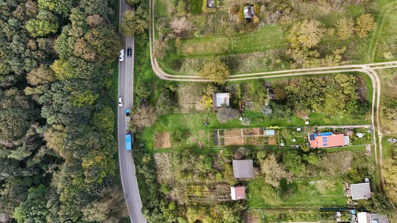 Aerial view of garden cottages near the forest in Hlohovec with a road.