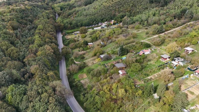The area near Hlohovec with numerous cottages and a forest along the road.