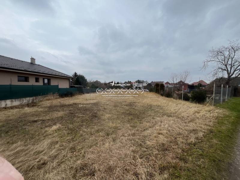 The exterior of a family house on Ladislav Novomeský Street in Hlohovec with a garden and a fence.