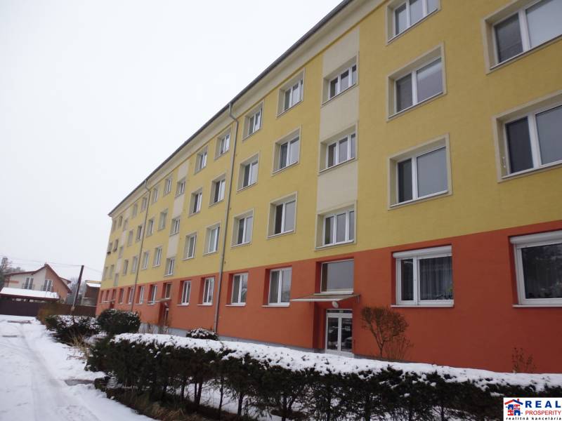 The building on 17. novembra Street in Prešov with a colorful facade and snowy surroundings.