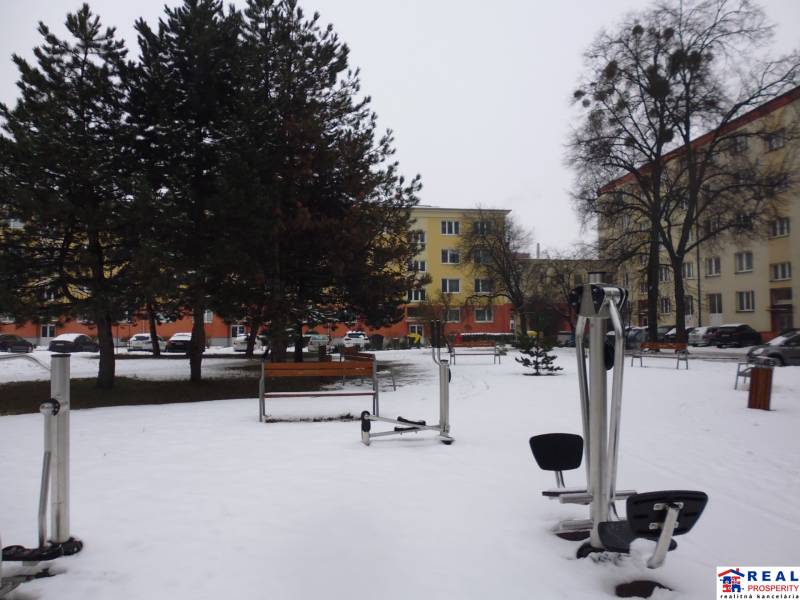 Snow-covered outdoor fitness equipment on November 17th in Prešov in front of a 1-bedroom apartment.