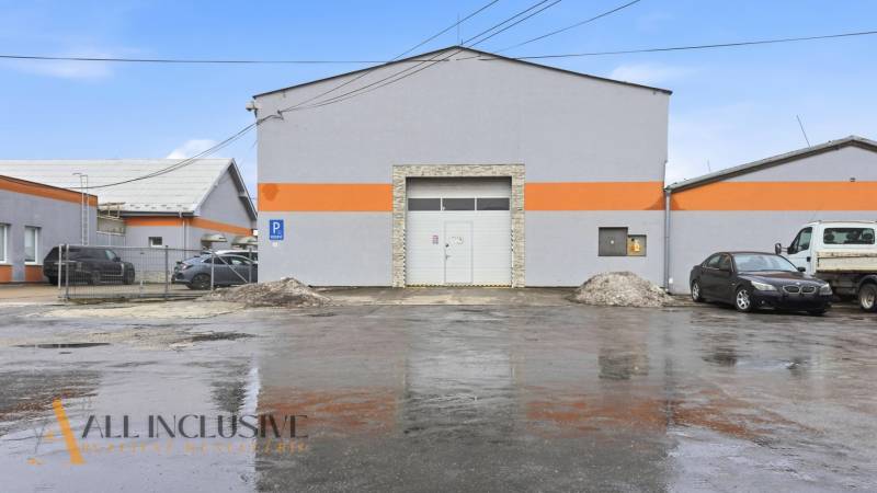 The building of commercial premises on Pod kalváriou Street in Topoľčany with parked cars.